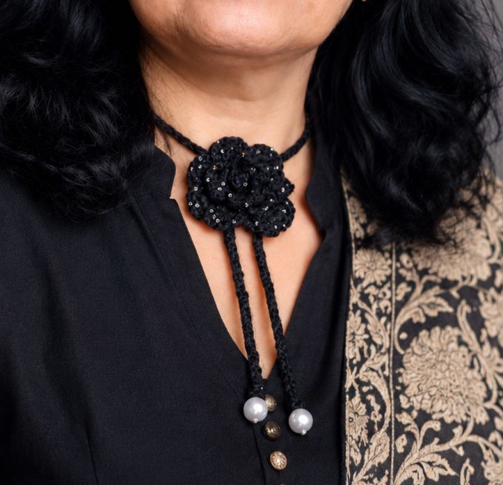 Beaded crochet rose necklace worn at the neck